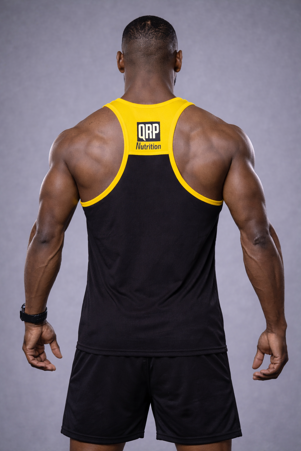 qrp nutrition muscular man wearing black and yellow gym vest NOT HERE TO TALK back