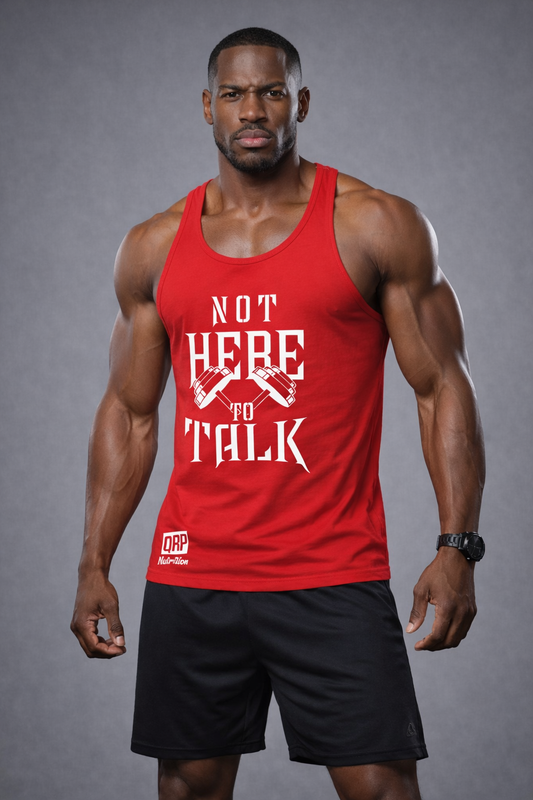 Man wearing a red tank top with text and black shorts on a gray background