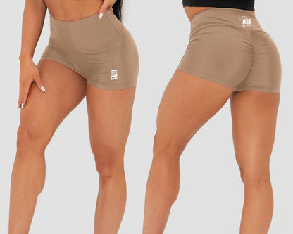 Beige athletic shorts worn by a person on a plain background
