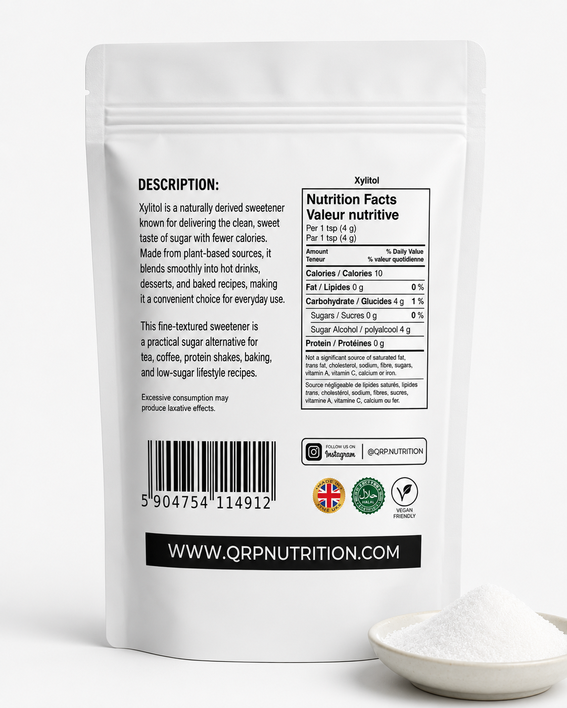 The back of a white stand-up pouch of QRP Nutrition Xylitol sweetener, shown on a white background with a small pile of white powder in a spoon in the lower right corner.